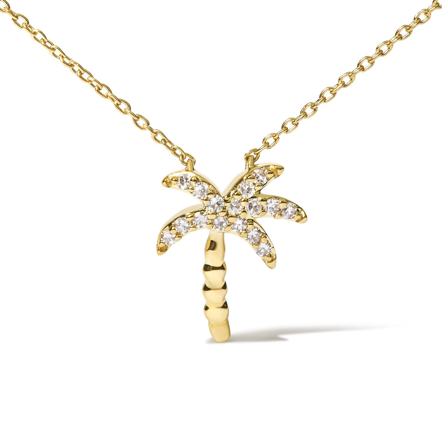 Yellow metal necklace with a palm tree-shaped pendant featuring round white gemstones in pave setting, shown from the front on a white background.
