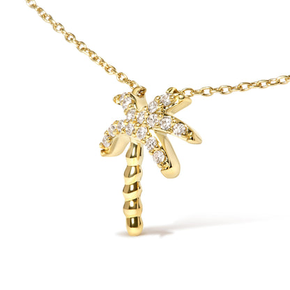 Close-up front angle of a yellow metal necklace with a palm tree pendant decorated with white round pave set gemstones.