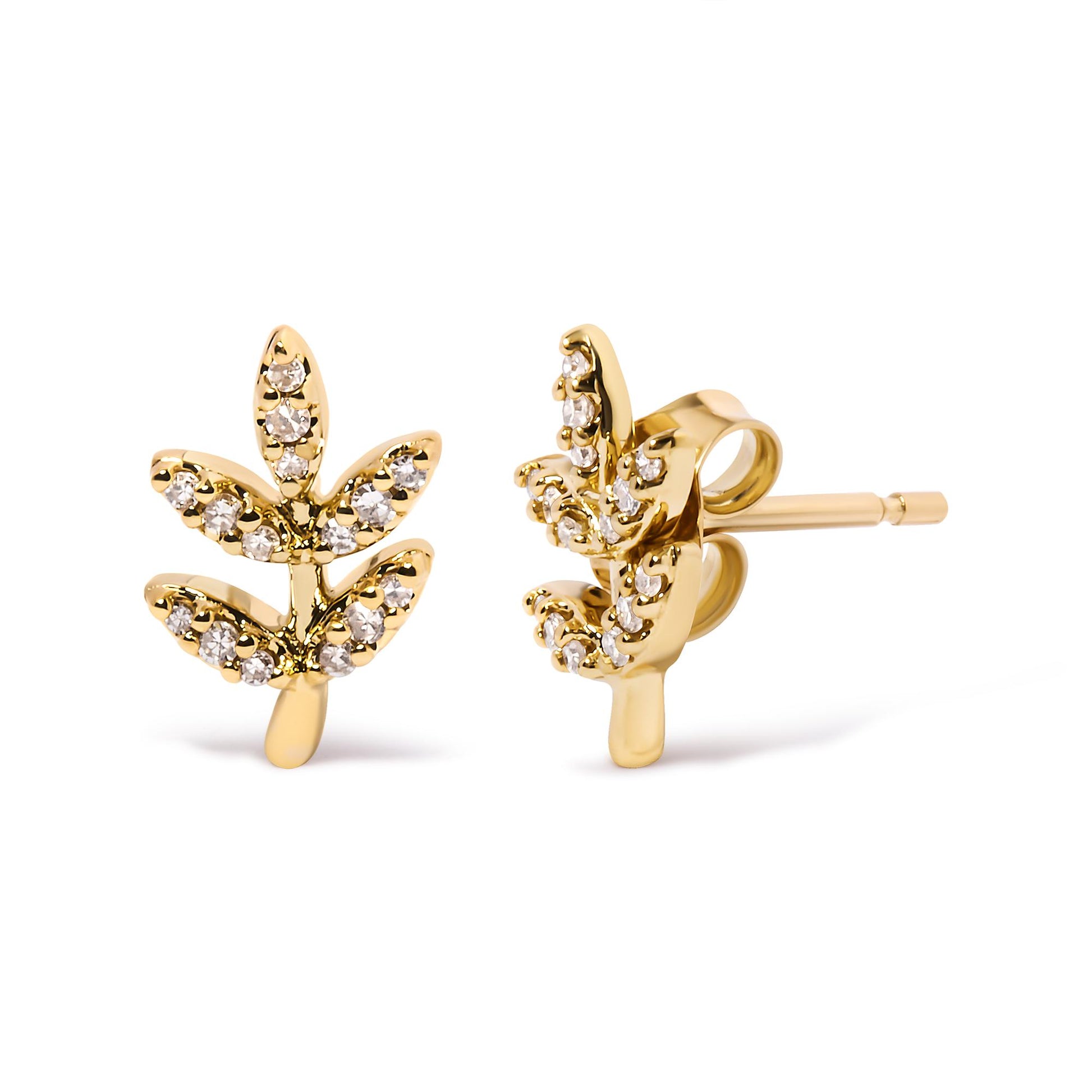 Close-up front and side view of yellow metal earrings shaped like leaves with white gemstones in pave settings.
