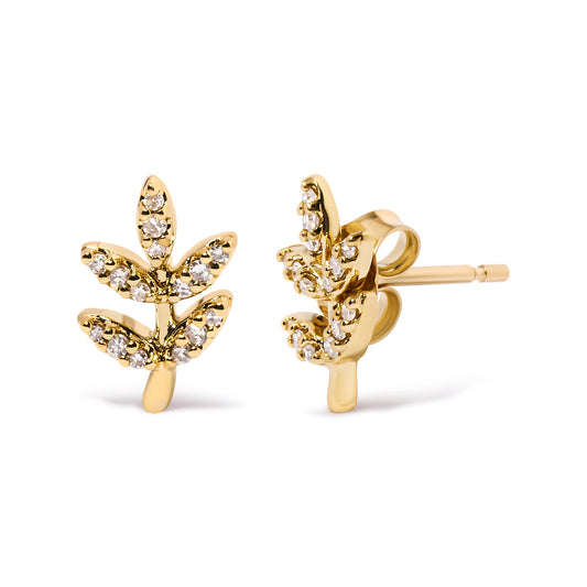 Close-up front and side view of yellow metal earrings shaped like leaves with white gemstones in pave settings.