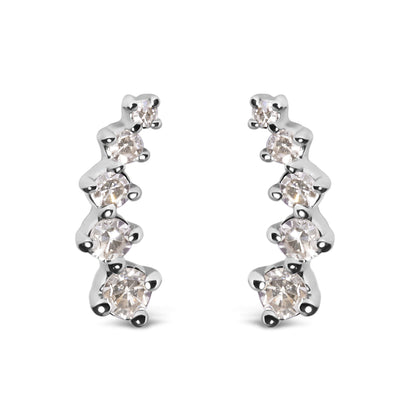 Front-facing shot of a pair of white metal earrings, each featuring a curved row of round white gemstones in prong settings.