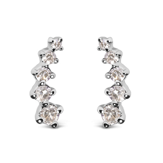 Front-facing shot of a pair of white metal earrings, each featuring a curved row of round white gemstones in prong settings.