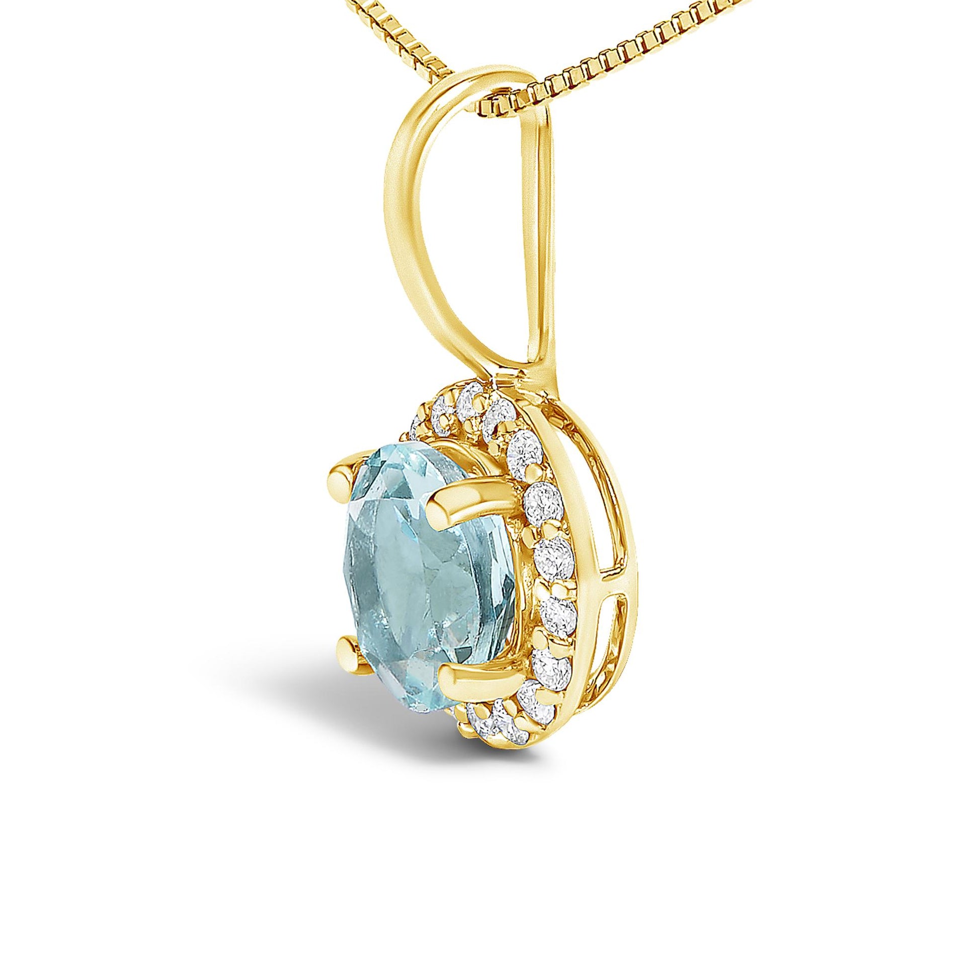 Close-up angled view of a yellow metal necklace pendant featuring a round blue gemstone in a four-prong setting, surrounded by small white round gemstones in a shared prong setting.