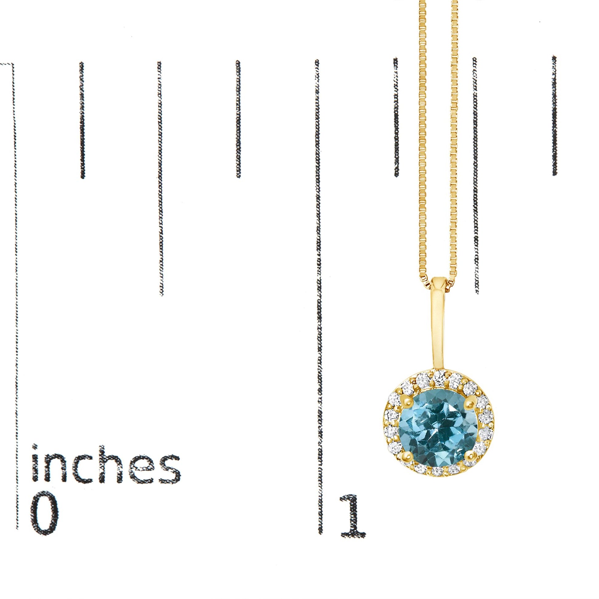 Yellow metal necklace with a round blue gemstone pendant surrounded by small white gemstones, shown on a scale from a front angle.