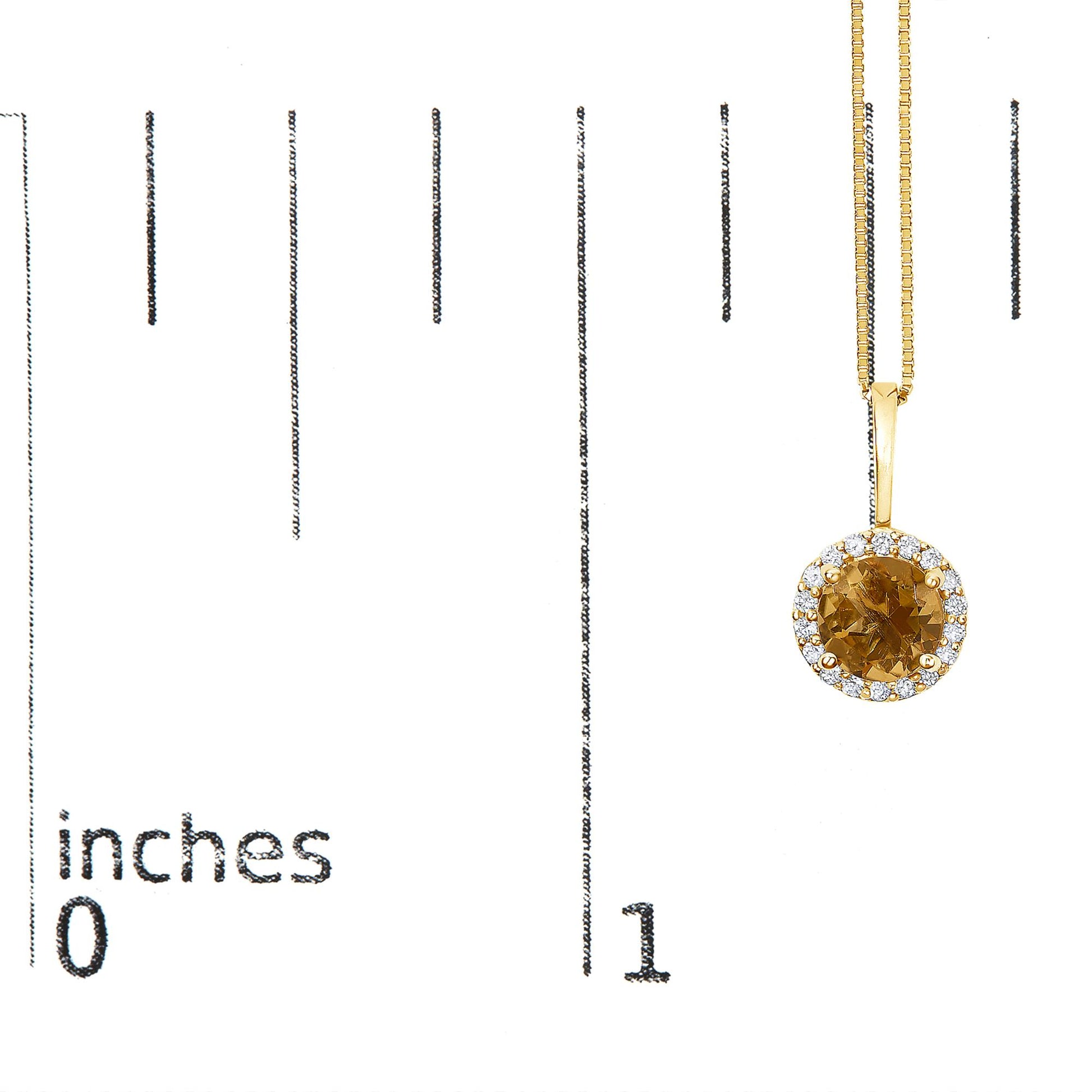 Yellow metal necklace with a round orange gemstone pendant surrounded by small white gemstones, shown on a scale from a front angle.