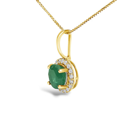 Yellow metal necklace with a pendant featuring a round green gemstone in a four-prong setting, surrounded by a halo of round white gemstones in a shared prong setting, shown in a close-up front angle.