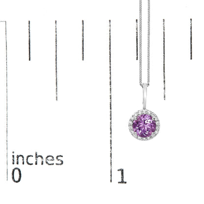 White necklace with round purple gemstone pendant surrounded by round white gemstones in a shared prong setting, shown on a scale with the image taken from the front.