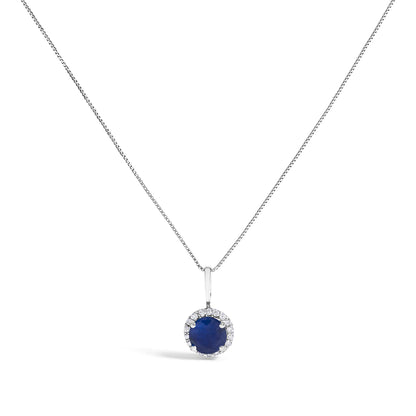 White metal necklace with a round blue gemstone pendant surrounded by round white gemstones, shown from the front on a white background.