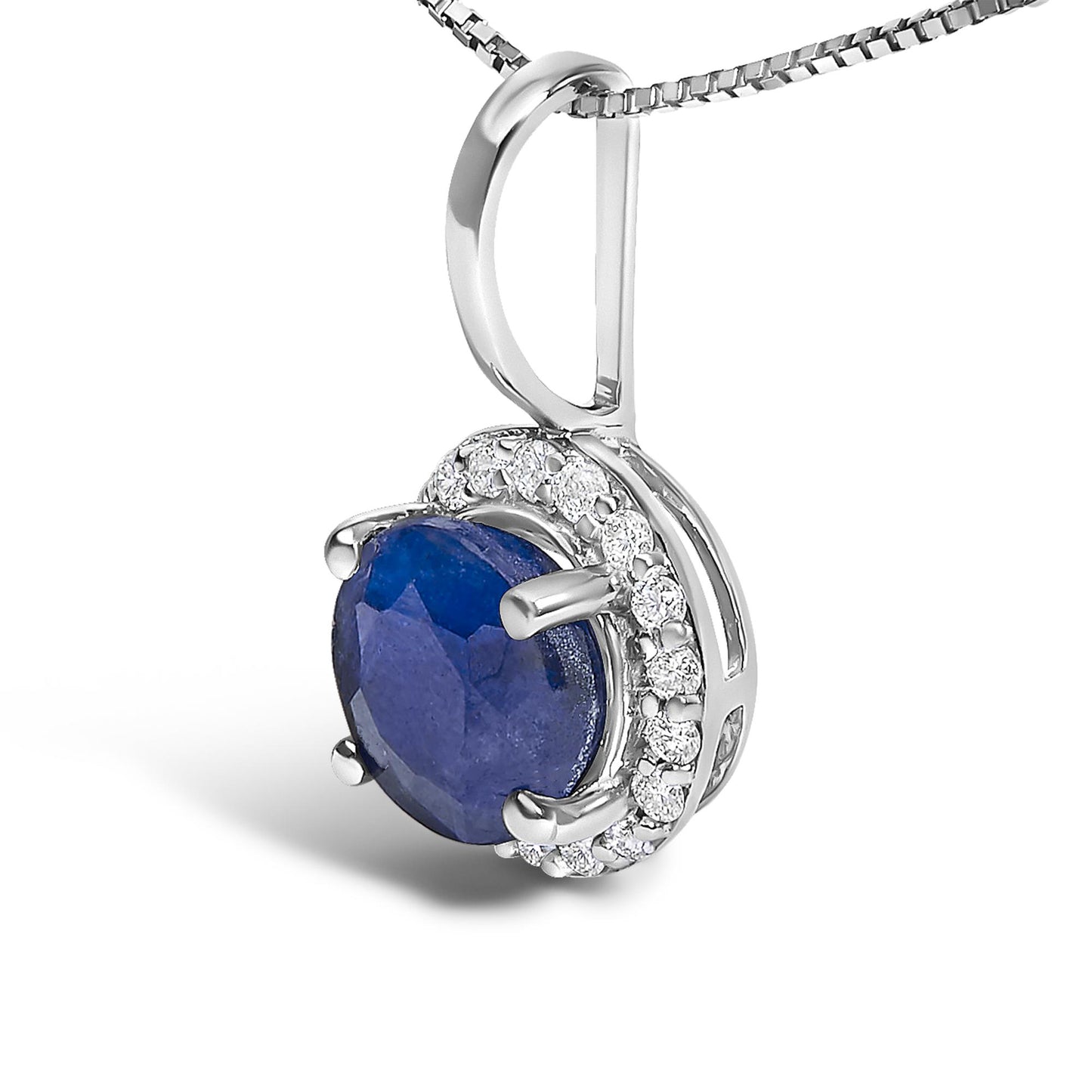 Close-up front angle of a white metal necklace pendant featuring a round blue gemstone in a four-prong setting, surrounded by a halo of small round white gemstones in a shared prong setting, shown on a white background.