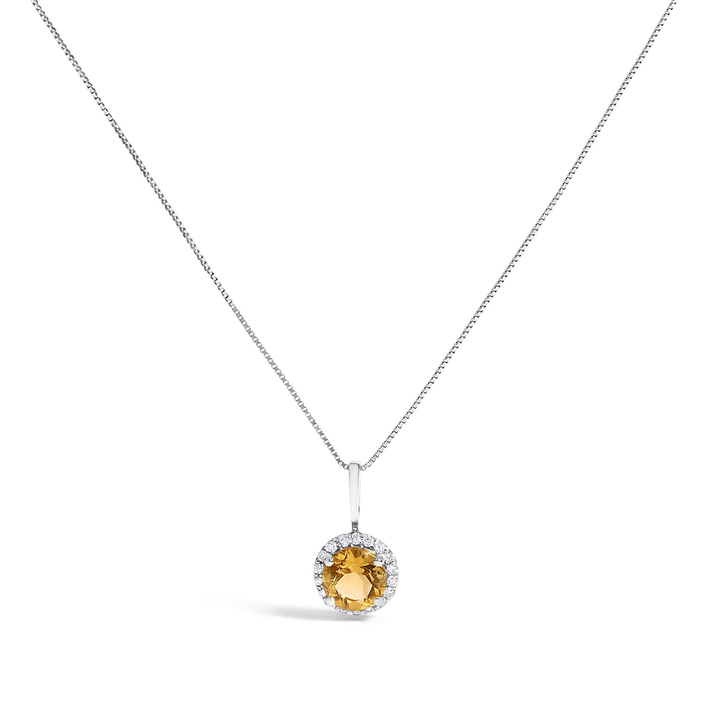 Front-facing shot of a white metal necklace with a round orange gemstone pendant surrounded by small white round gemstones in shared prong settings.