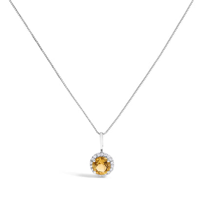 Front-facing shot of a white metal necklace with a round orange gemstone pendant surrounded by small white round gemstones in shared prong settings.