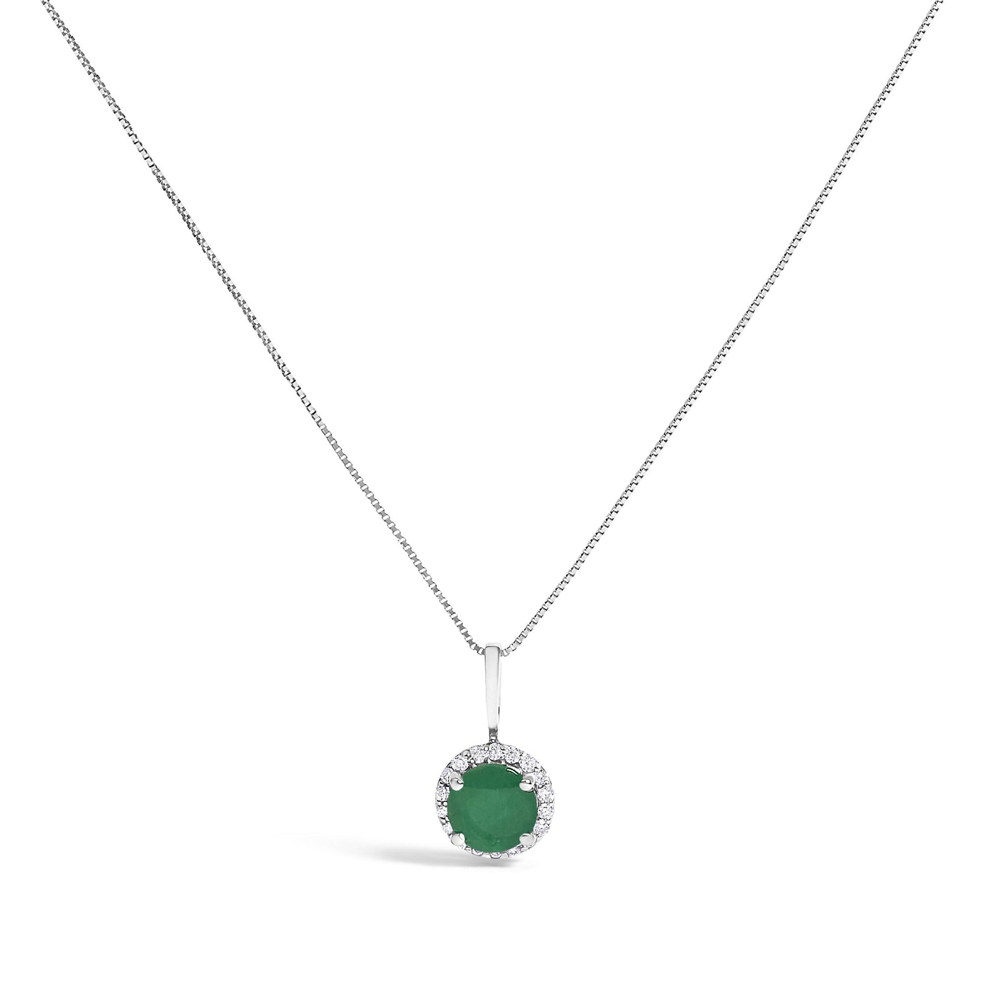 Front view of a white metal necklace with a round green gemstone pendant surrounded by small round white gemstones in a shared prong setting.
