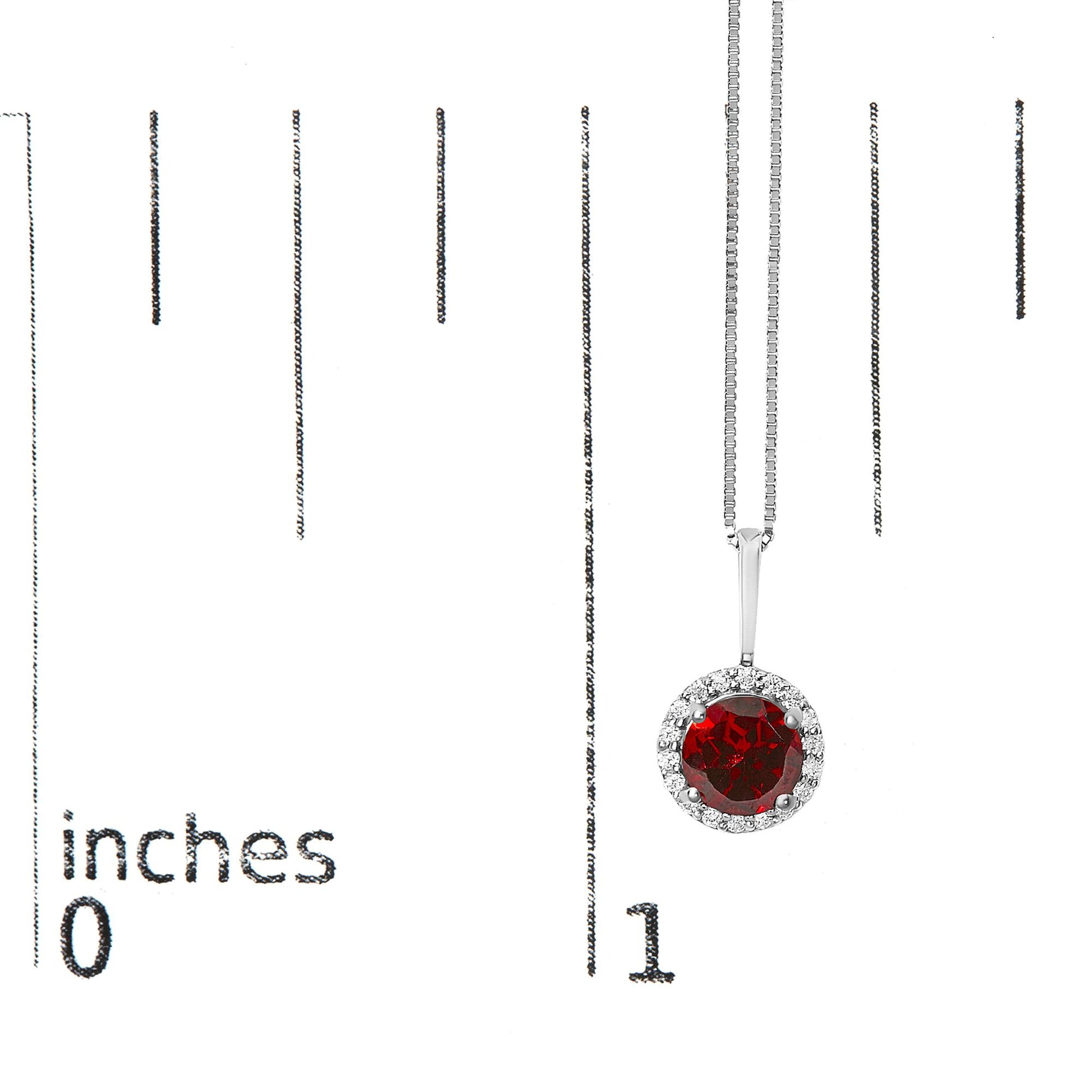 White metal necklace with a round red gemstone pendant surrounded by a halo of small white gemstones, shown hanging on a scale with inch measurements, front view.