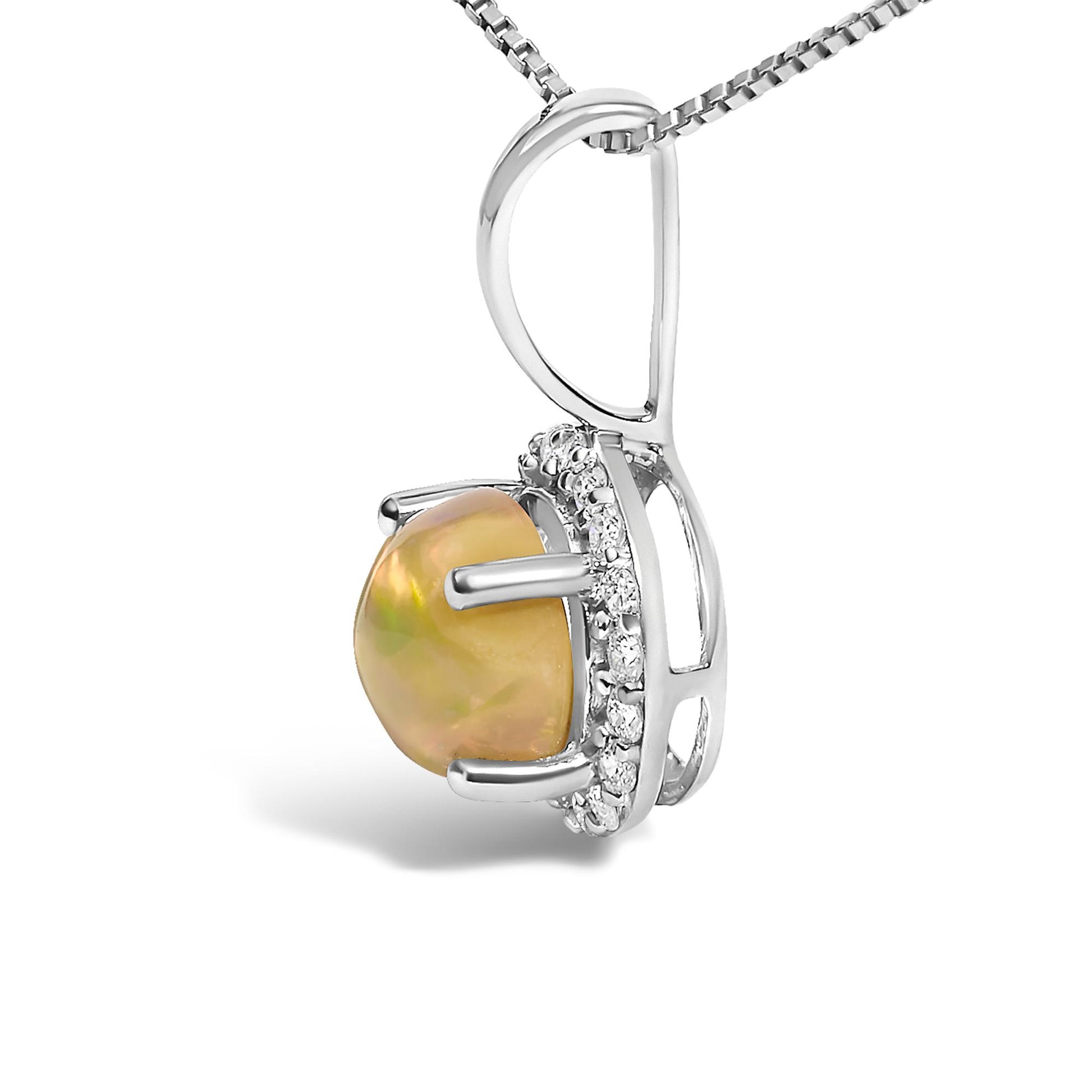 Close-up side angle of a white metal necklace pendant featuring a round multi-color opal gemstone in a four-prong setting surrounded by round white gemstones in a shared prong setting.