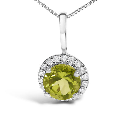 White metal round pendant necklace with a central round green gemstone surrounded by a halo of small round white gemstones, shown in a front close-up angle.
