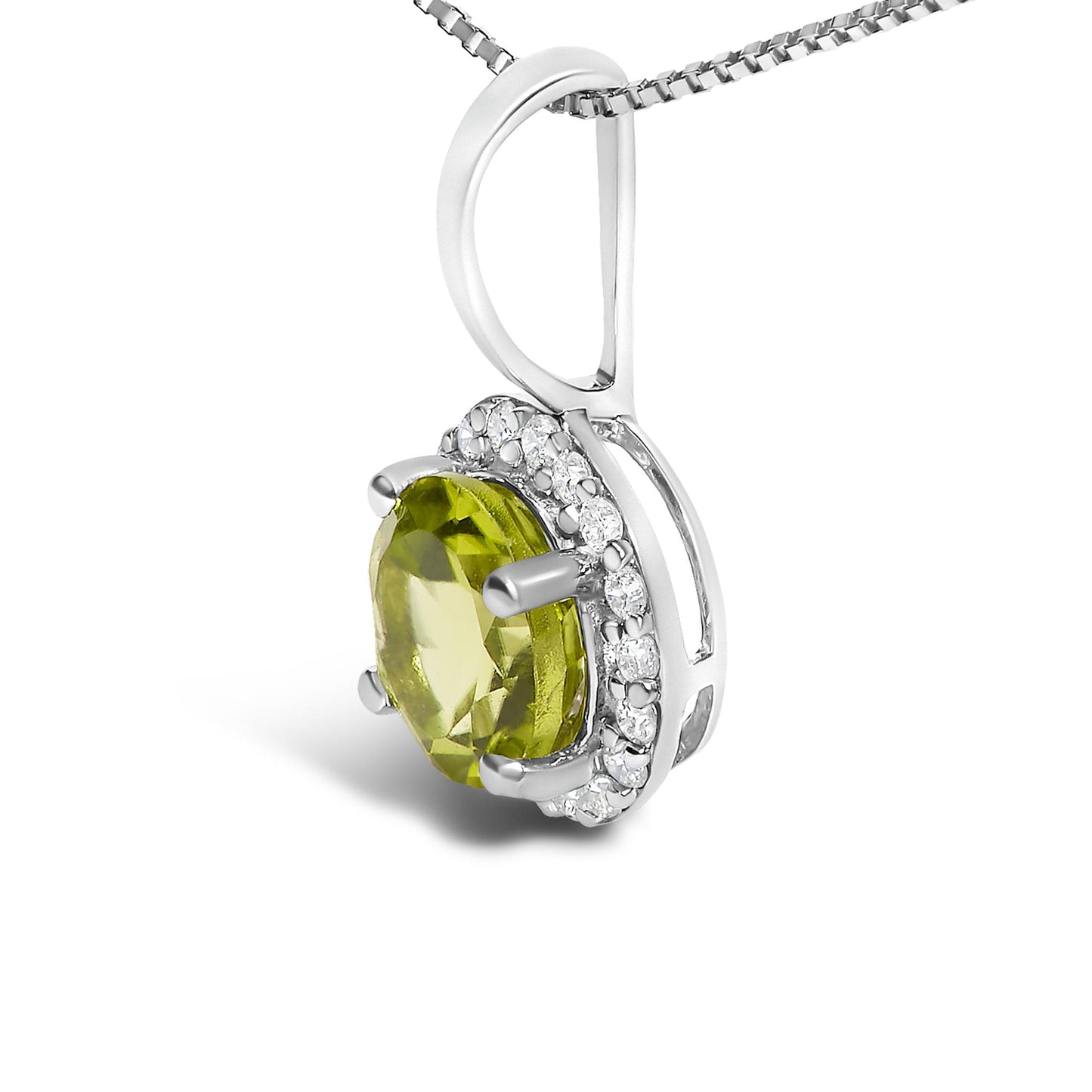 Close-up front angle of a white metal necklace pendant featuring a round green gemstone in a four-prong setting, surrounded by a halo of round white gemstones in a shared prong setting, shown on a white background.