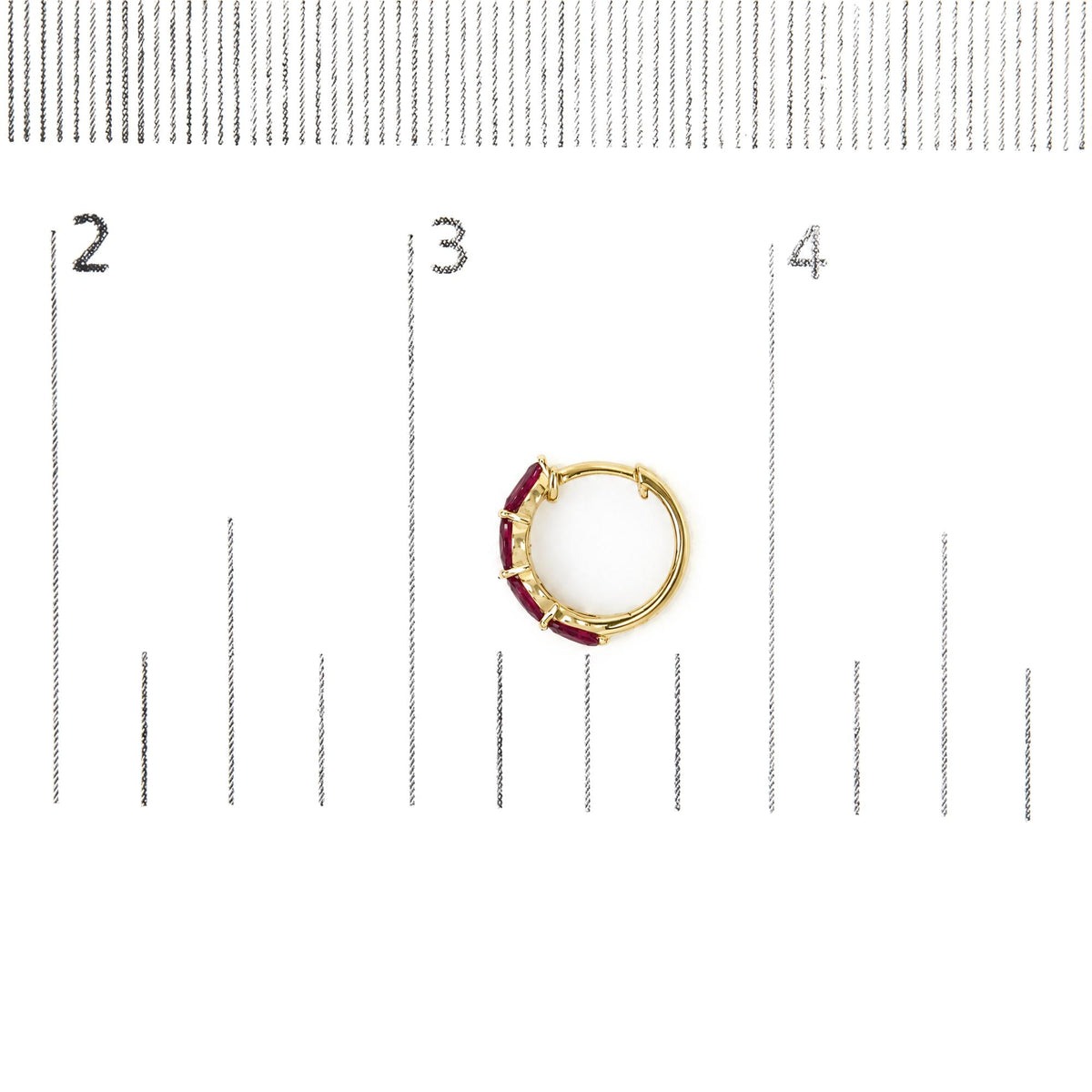 Single yellow metal hoop earring set with red marquise-shaped gemstones along the outer curve, shown flat on a white background with a measurement scale.