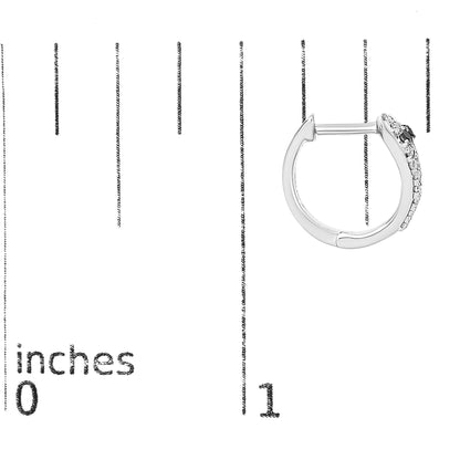Close-up side view of a white metal hoop earring with white and black round gemstones in prong settings, shown on a scale.