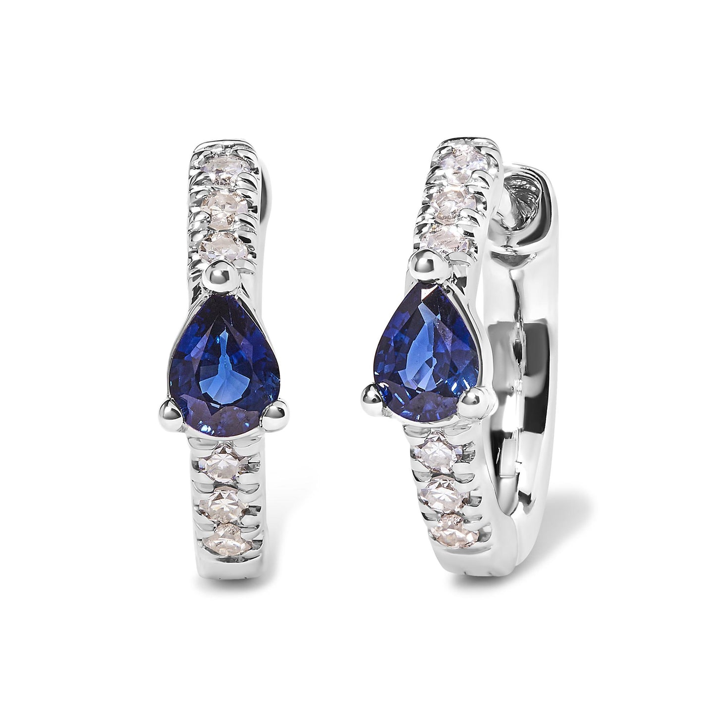 Front angle view of white metal hoop earrings with round pave-set white gemstones along the hoop and a pear-shaped blue gemstone in a three-prong setting at the center.