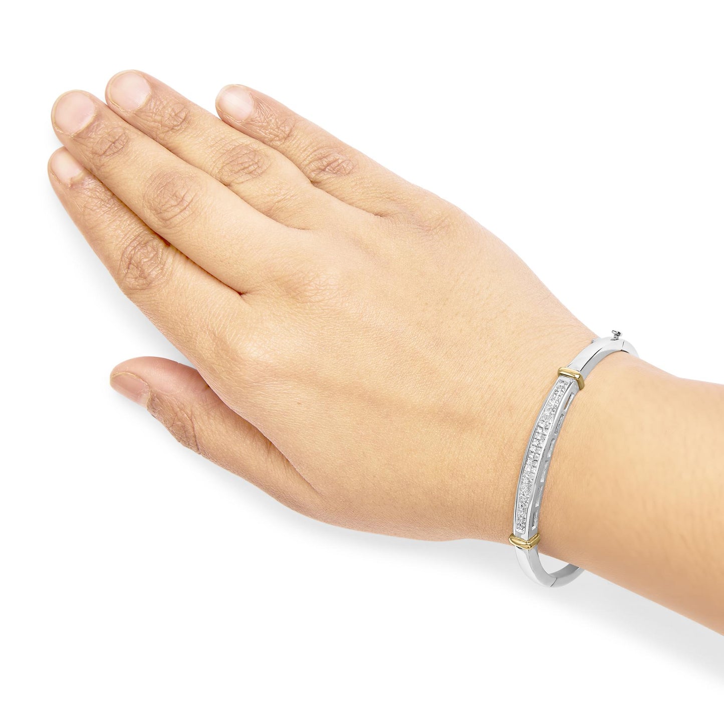 Bracelet with white and yellow metal featuring a row of white princess-shaped gemstones in an invisible setting, shown on a model's wrist from a top angle.