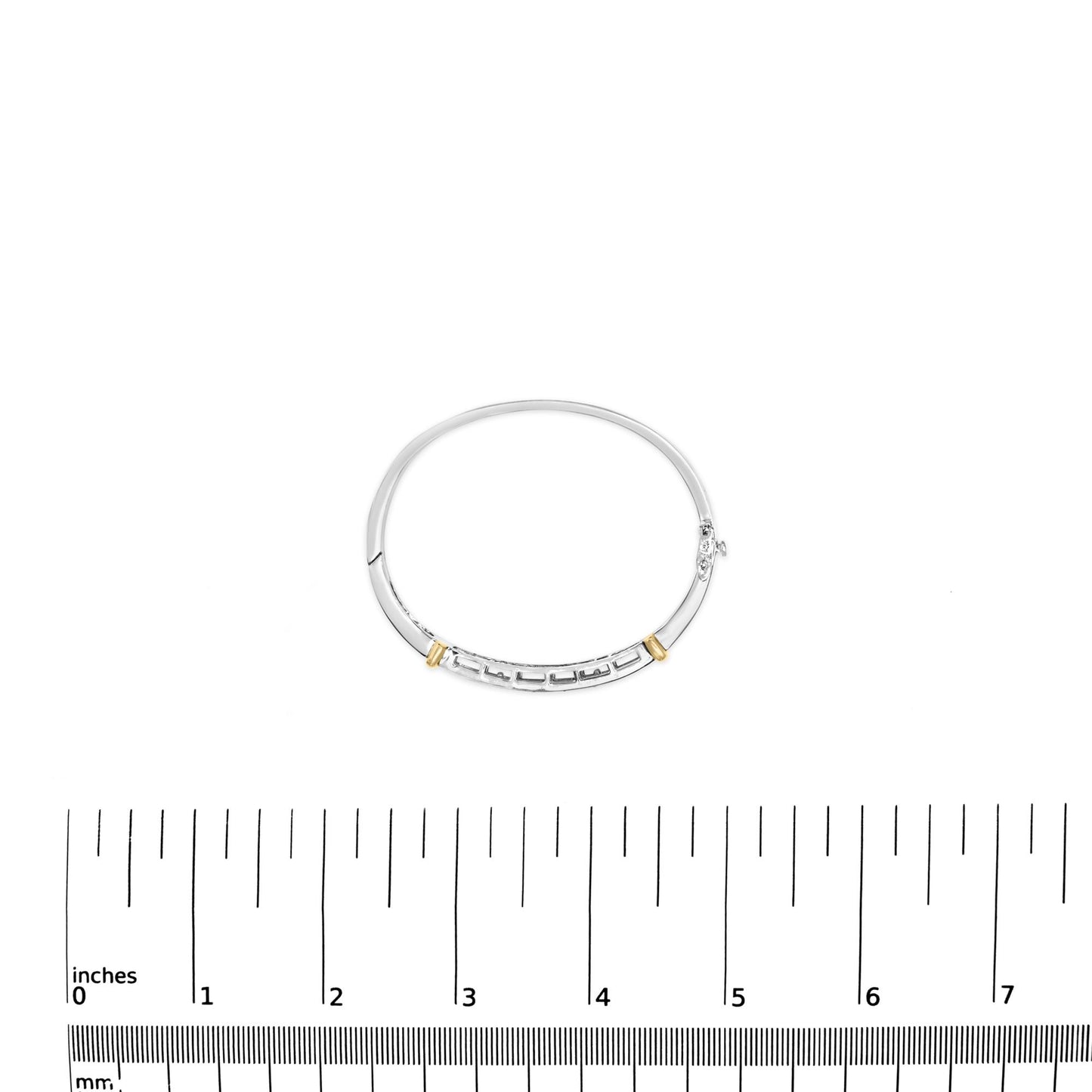 Bracelet in yellow and white metal with white princess shape gemstones in invisible setting, shown from top angle, placed on a ruler for size reference.