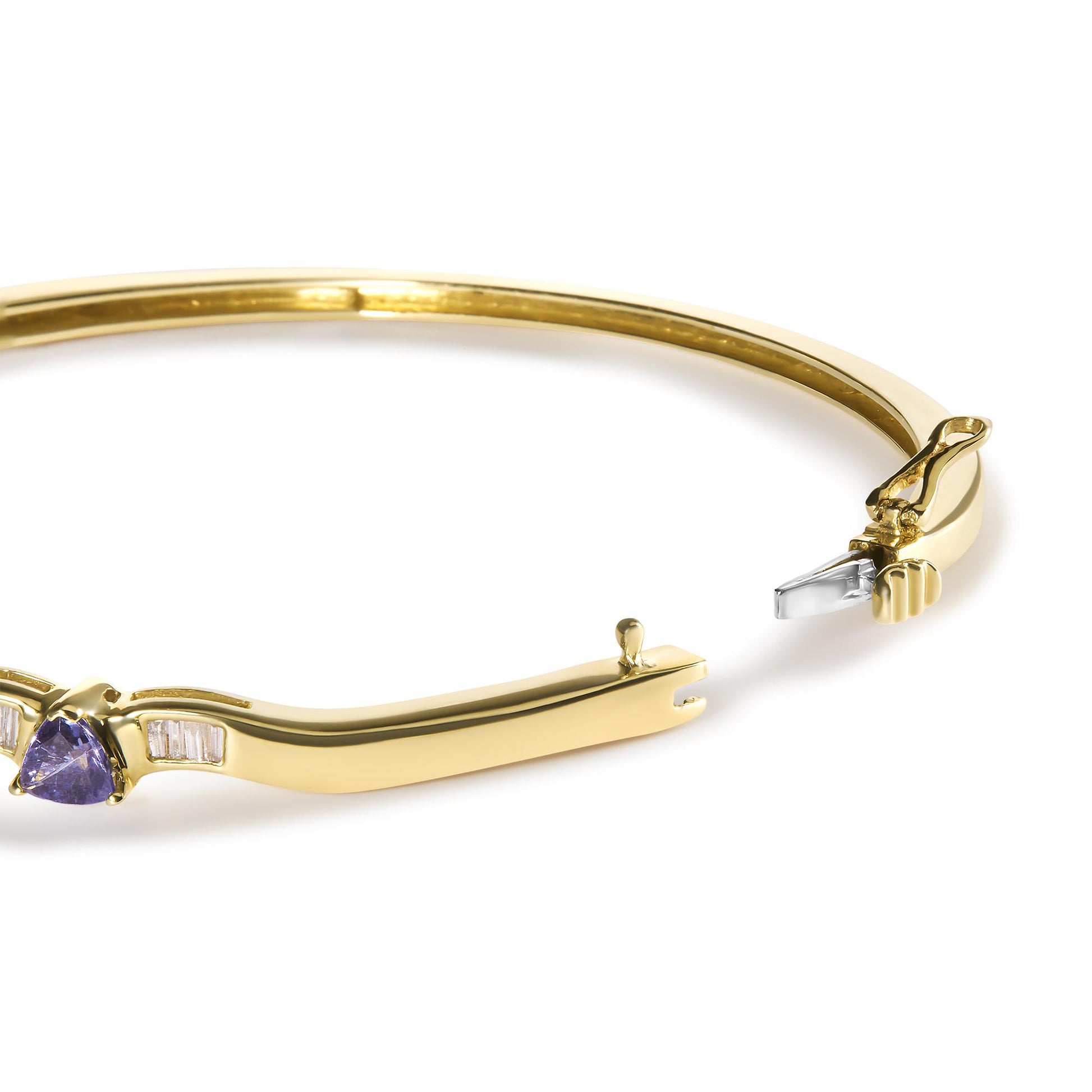 Close-up angled view of an open yellow bracelet featuring white baguette-shaped gemstones in a channel setting and a single blue trillion-shaped gemstone in a three-prong setting near the clasp.
