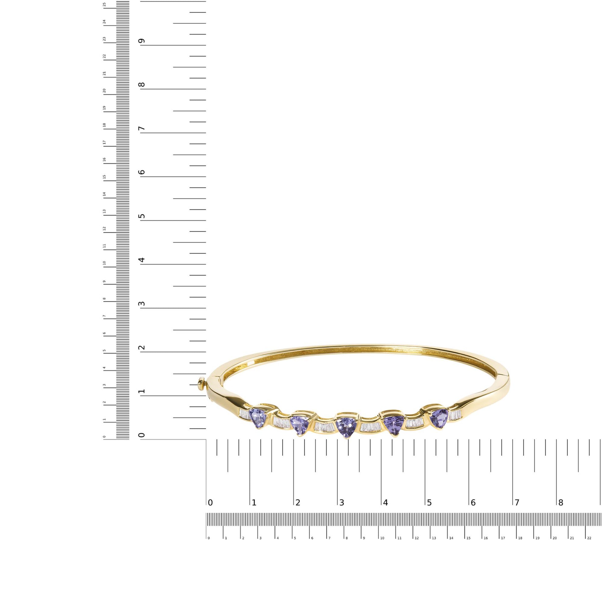 Yellow metal bracelet with alternating trillion-shaped blue gemstones and baguette-shaped white gemstones, shown on a scale, front view.