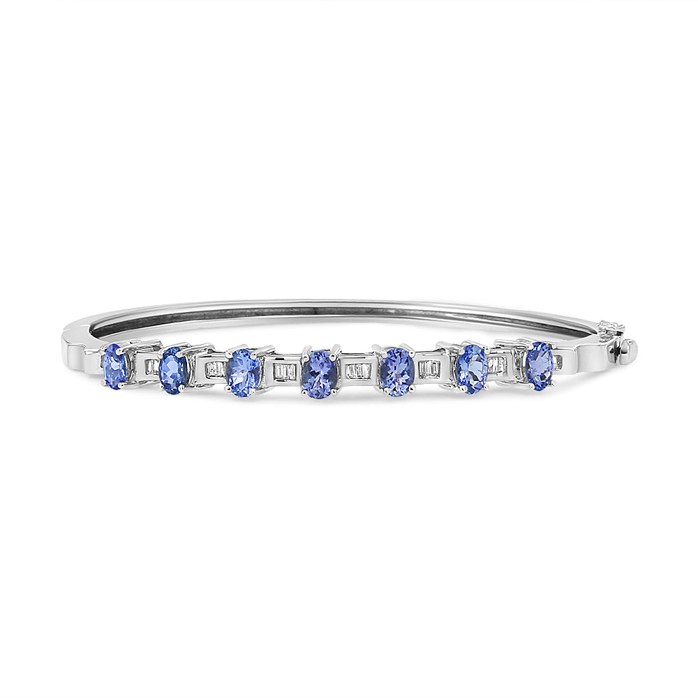 Side view of a white metal bracelet featuring alternating blue oval-shaped gemstones in prong settings and white baguette-shaped gemstones in channel settings.