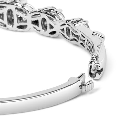 Close-up angled view of a white metal bracelet featuring round white gemstones in prong settings and a secure clasp.
