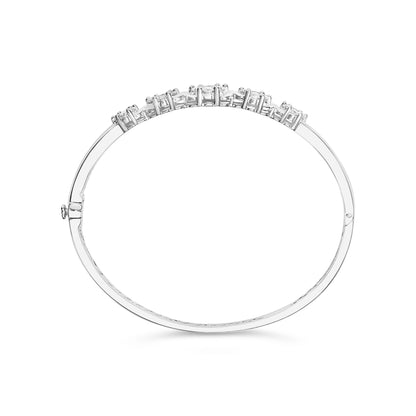 Top-down view of a white metal bracelet with round white gemstones in prong settings along one side.