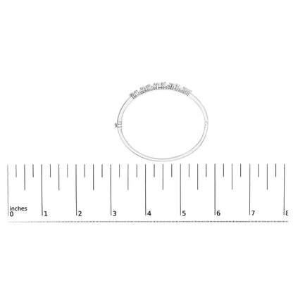 White metal bracelet with round white gemstones in prong settings, shown flat on a ruler for size reference, top-down view.