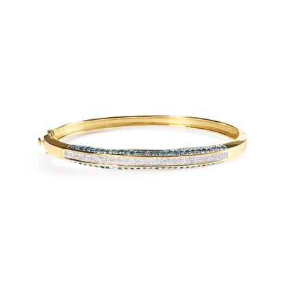 Yellow metal bracelet with white princess-shaped gemstones in channel setting and blue round gemstones in pave setting, shown in a front elevated side view.