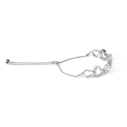 White metal bracelet with linked heart shapes, some adorned with small white gemstones, shown against a white background from a side angle.