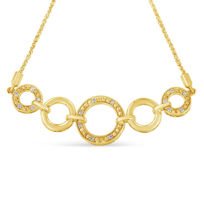 Front-facing view of a yellow metal bracelet with interconnected circular links, three of which are adorned with round white gemstones in a pave setting.