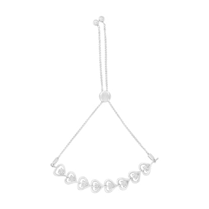 Front-facing shot of a white metal bracelet with a sliding clasp, featuring a row of heart-shaped links each set with a round white gemstone in a miracle setting.