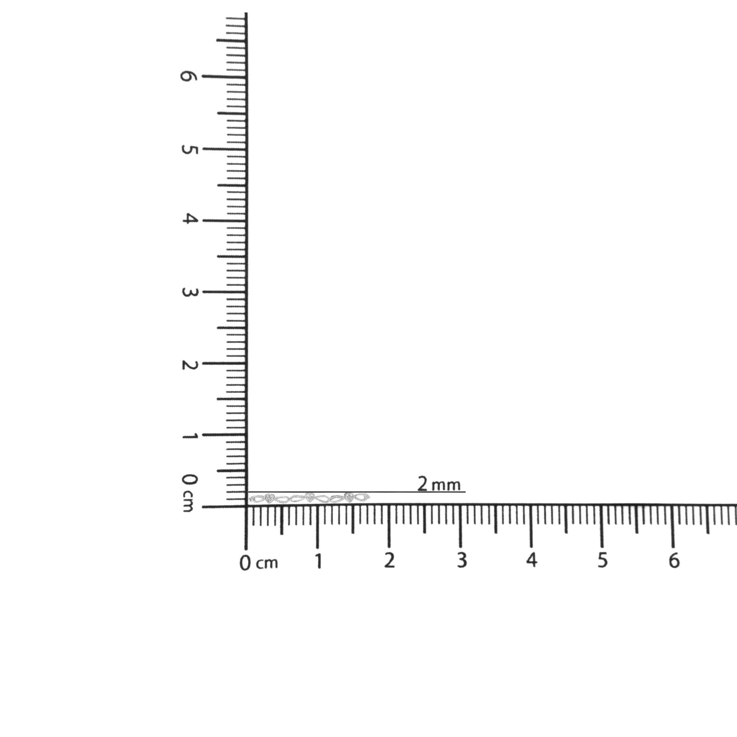 White metal bracelet with three round white gemstones set in a miracle setting, displayed on a ruler for size reference, shot from the top angle.