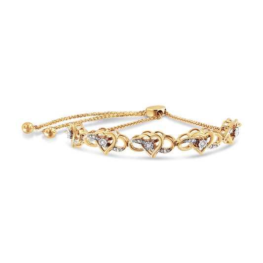 Yellow metal bracelet with heart-shaped links accented with white round gemstones in prong and miracle settings, shown in a front angled view.