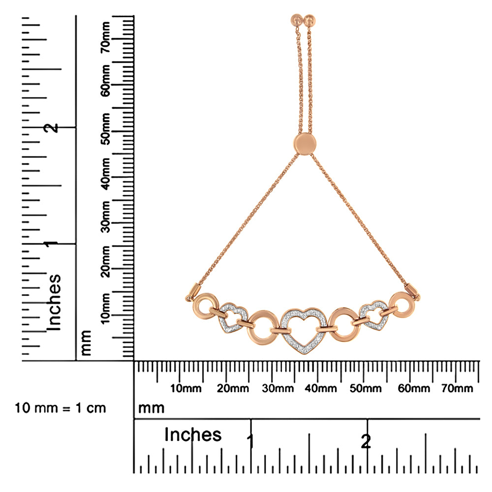 Bracelet with alternating plain and gemstone-encrusted heart-shaped and circular links in white and rose metal colors, shown flat on a ruler for size reference, photographed from the front.