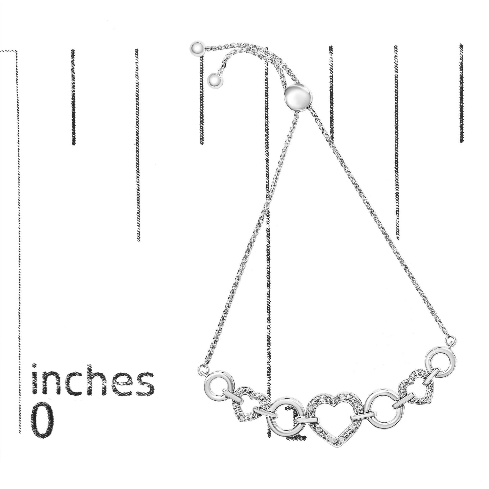 White metal bracelet with heart-shaped and round links, some paved with white gemstones, shown flat on a ruler for size reference.