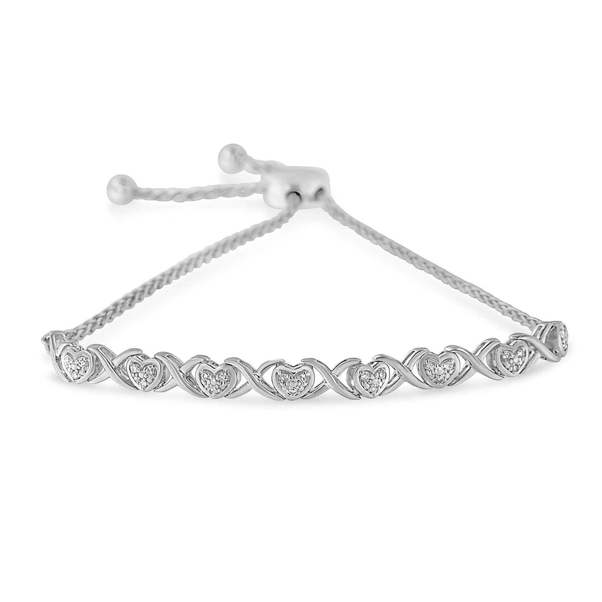 White bracelet with heart shapes featuring round white gemstones in pave setting, shown from a front angle.