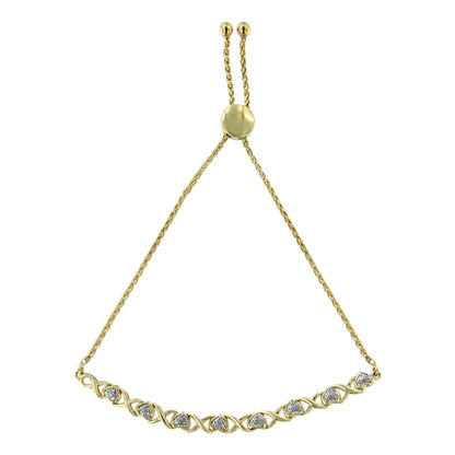 Yellow metal bracelet with round white gemstones in pave setting along the front, shown from a top-down angle.