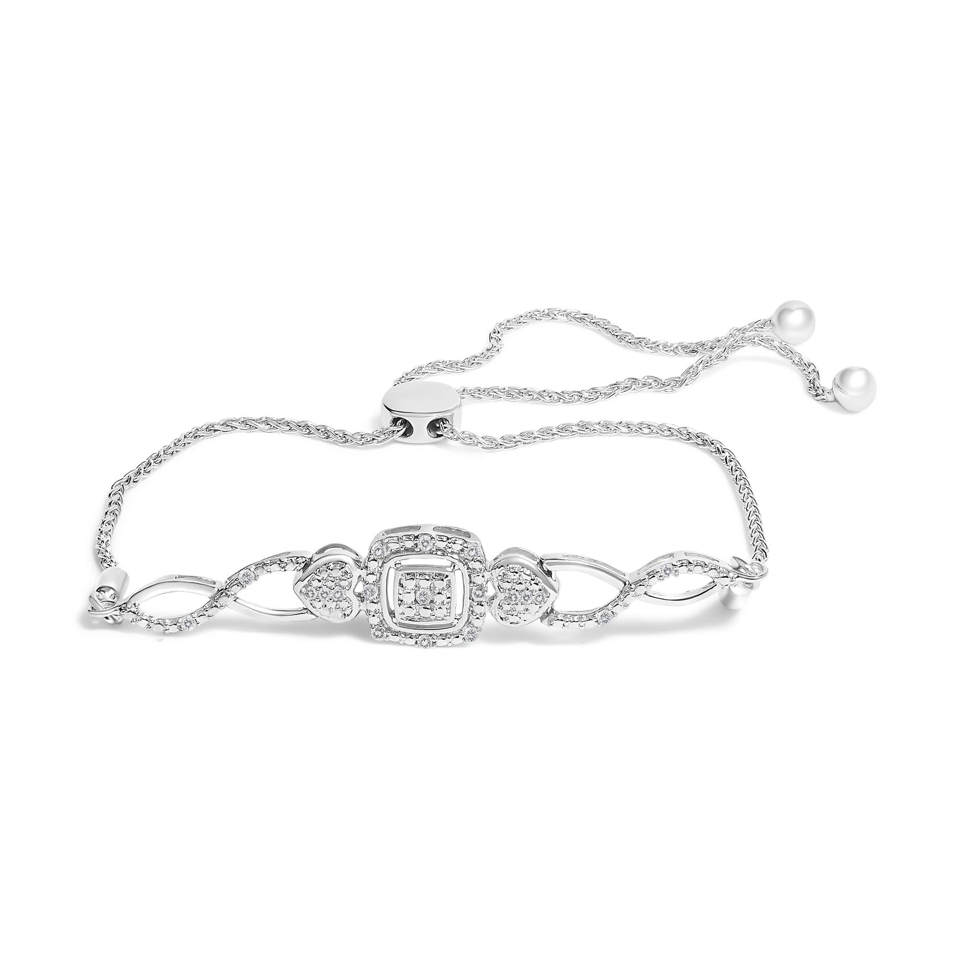 White metal bracelet with an adjustable chain, featuring heart and square motifs adorned with round white gemstones in pave setting, shown in a flat lay angled from above.