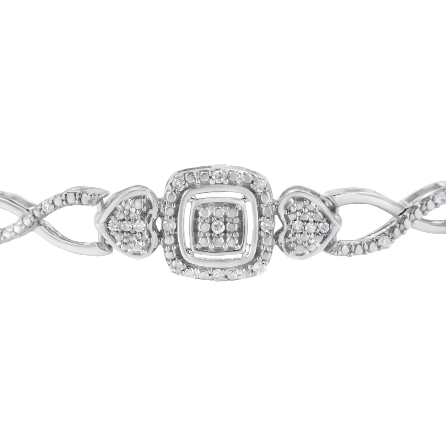 Close-up front view of a white metal bracelet featuring round white gemstones in pave setting, with heart-shaped and square decorative elements.
