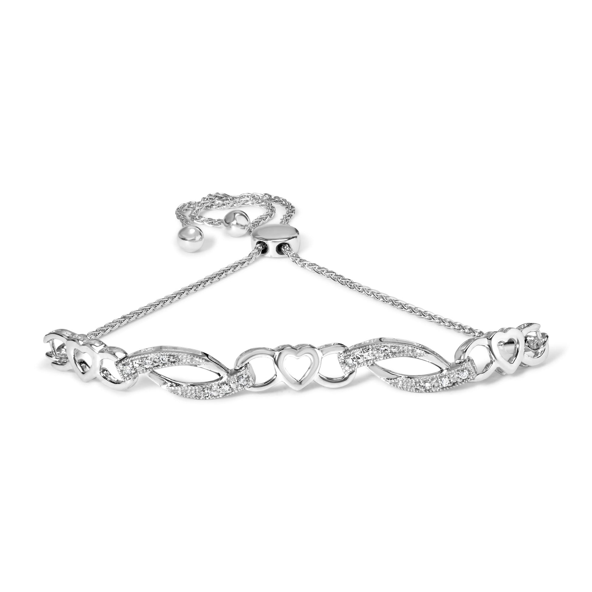 White metal bracelet with alternating open heart shapes and curved links set with white round gemstones in prong settings, shown from a front angle.