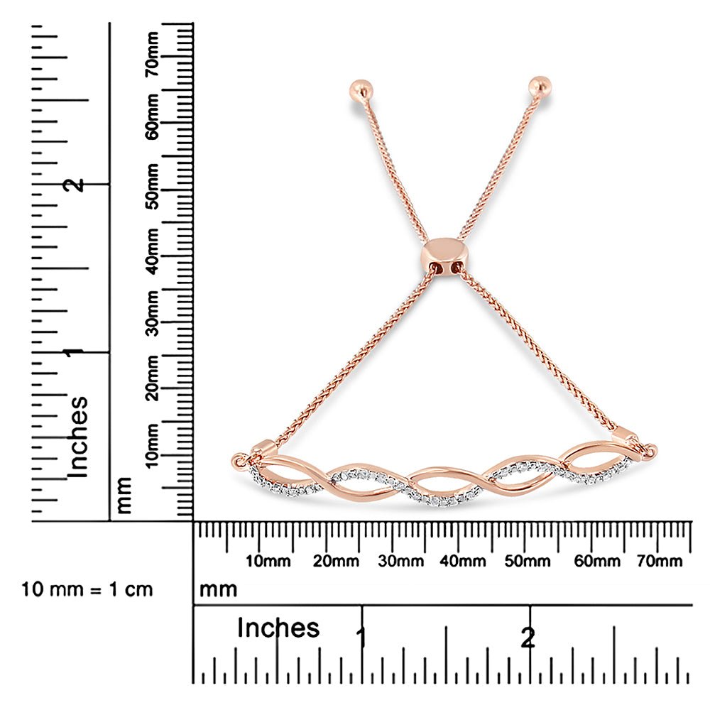 Rose metal bracelet with alternating curved design set with white round gemstones, shown on a ruler for size reference, top-down angle.