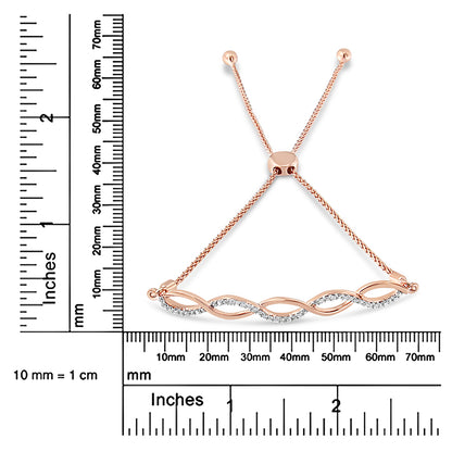 Rose metal bracelet with alternating curved design set with white round gemstones, shown on a ruler for size reference, top-down angle.