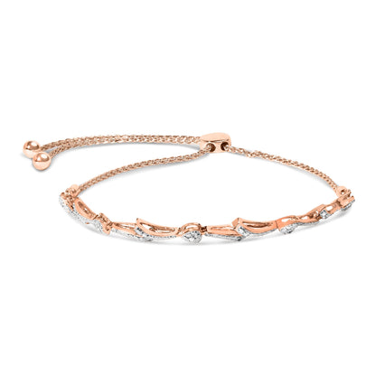 Rose metal bracelet with heart-shaped and curved segments paved with white round gemstones, shown flat from above.