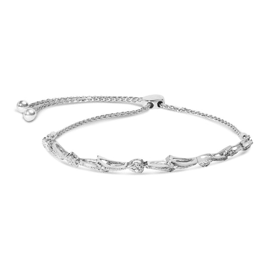 White metal bracelet with open curved links accented with small white gemstones in pave setting, shown in a front angled view.