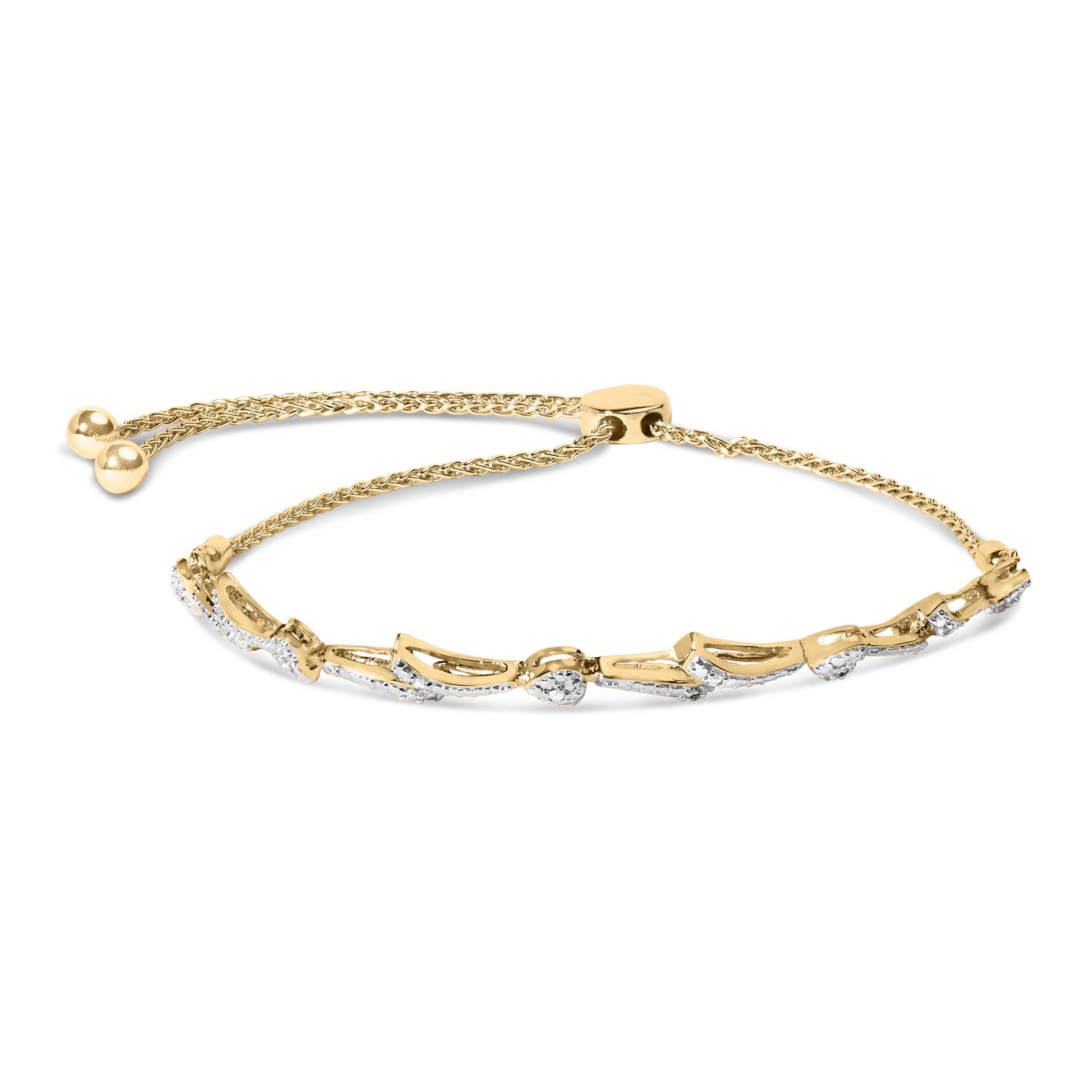 Yellow metal bracelet with heart-shaped and curved segments pavé set with white round gemstones, shown flat from above.