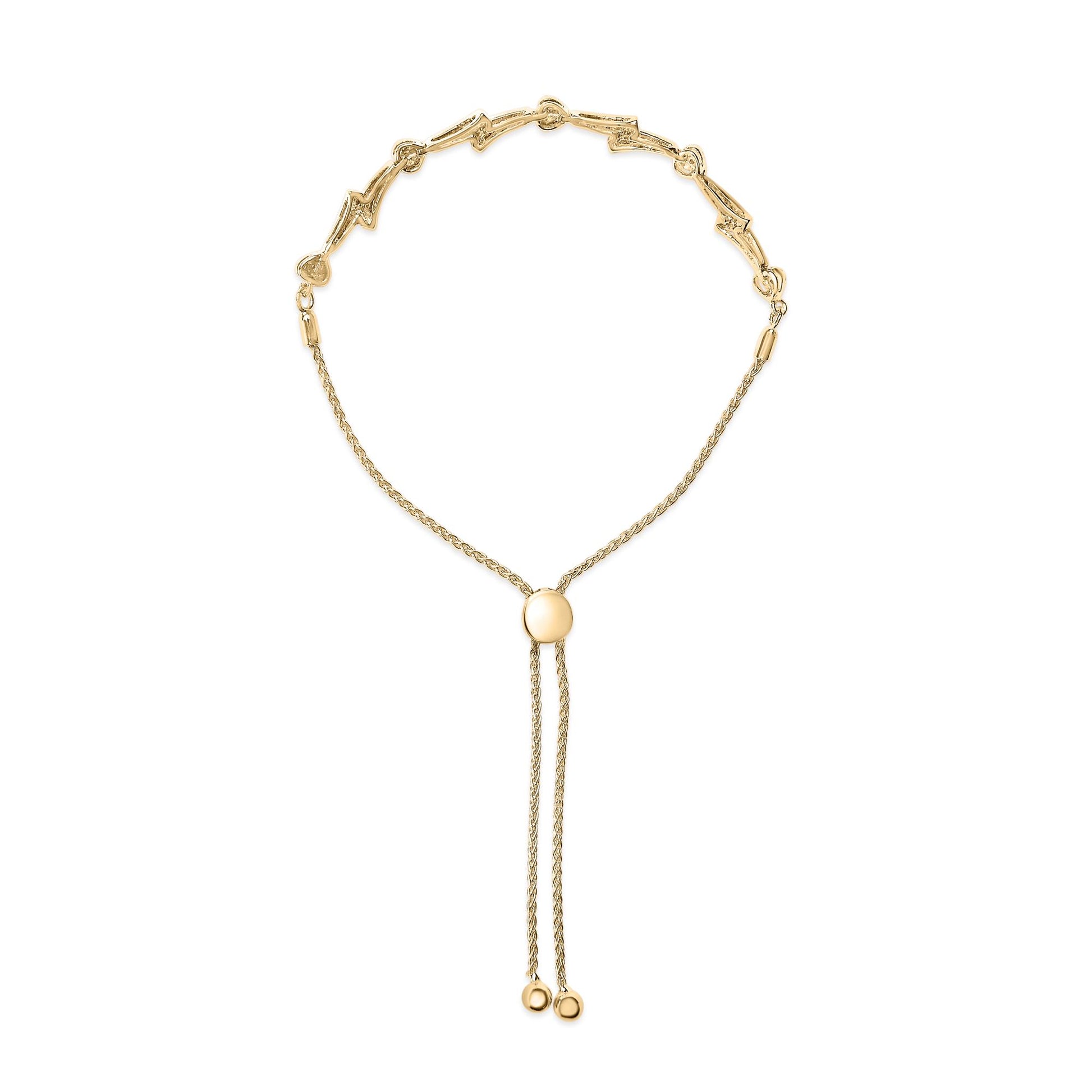 Yellow metal bracelet with heart shapes and pave-set round white gemstones, front-facing shot on a white background.